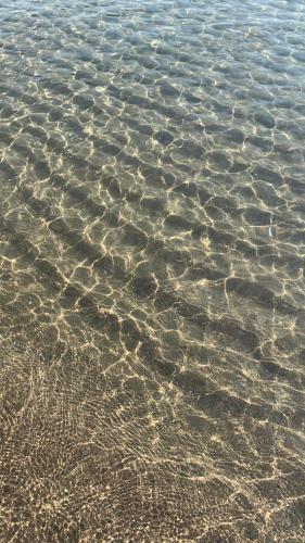 a close up of the water on a beach at La Dolce Vita in Agnone Bagni