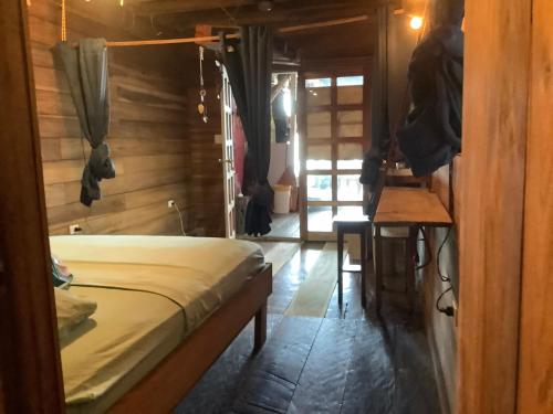a bedroom with a bed and a wooden wall at Life is Good in Bocas del Toro