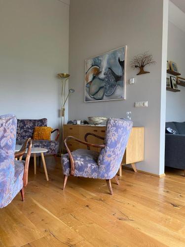 a living room with two chairs and a table at Norðurhof 5 845 Flúðir with private hot tube in Fludir