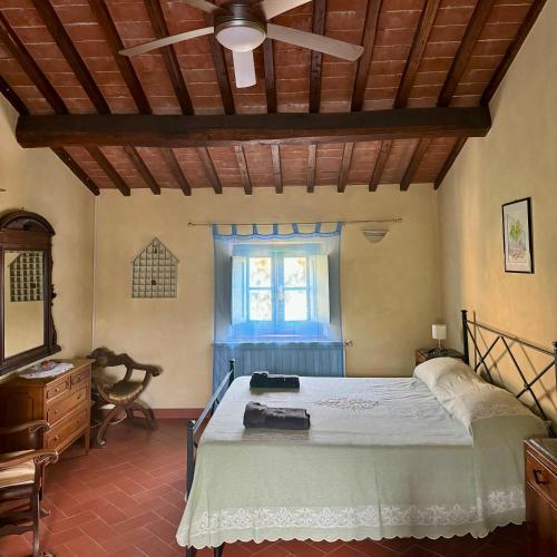 a bedroom with a bed and a window at Podere il Casone in Serravalle Pistoiese