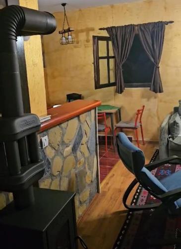 a living room with a fireplace and a stove at Zlatiborsko Srce 2 in Zlatibor