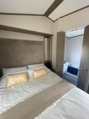a bedroom with a large white bed with two pillows at Coastguard 45 in Whitstable
