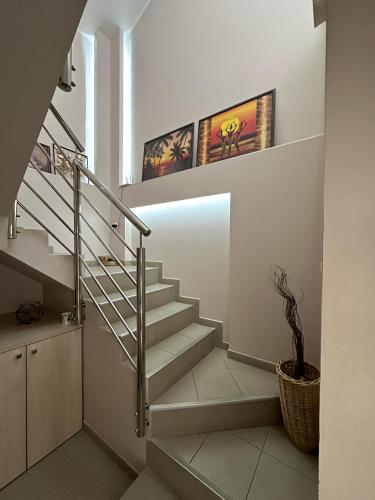 a spiral staircase in a house with a plant at Lovely Apartments Free STREET Parking in Novi Sad