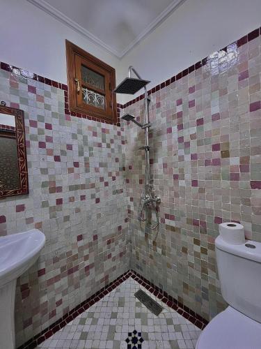 a bathroom with a toilet and a sink at Riad Safia in Rabat