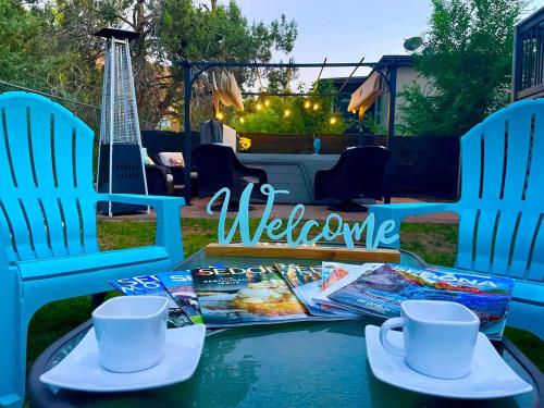 a table with two chairs and magazines on it at Sedona Red Rock Garden of Paradise Pets friendly and Hot tub in Sedona