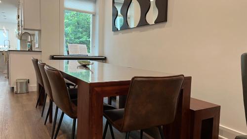 a dining room with a wooden table and chairs at Upscale 3BR I Walk Score 99 I Metro I Free Parking in Washington, D.C.