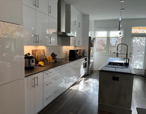 a kitchen with white cabinets and a counter top at Upscale 3BR I Walk Score 99 I Metro I Free Parking in Washington, D.C.