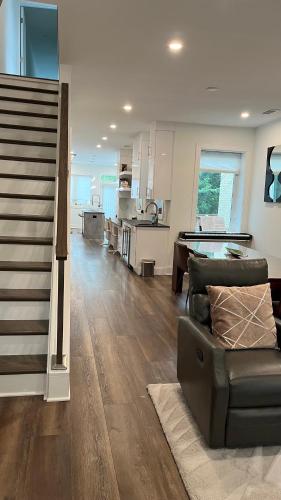 a large living room with a couch and a kitchen at Upscale 3BR I Walk Score 99 I Metro I Free Parking in Washington, D.C.