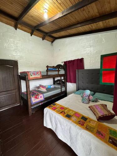 a bedroom with two beds in a room at Hospedaje San Martin - Finca completa - 18 personas in Pavas