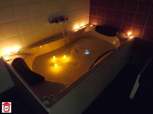 a bathroom with a tub with lights in it at Loboratorio Rural-Cuenta hasta 3 in Umbrías