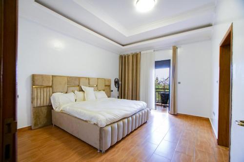 a bedroom with a large bed in a room at Lux Holidays Villa in Kigali