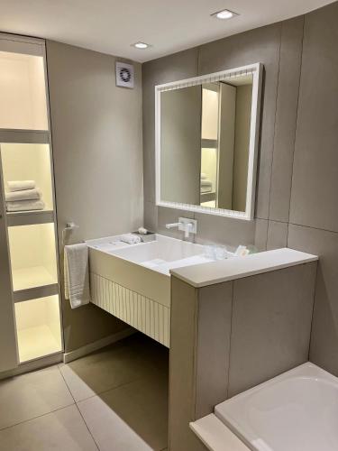 a bathroom with a sink and a mirror at Holiday Inn Rosario by IHG in Rosario