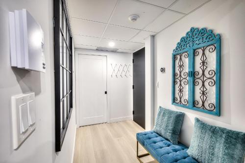 a living room with a blue couch and a door at Montreal Restful Nights, Adventure Days await! in Montréal