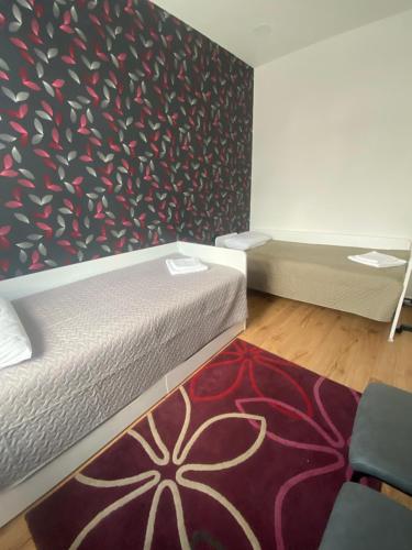 a bedroom with a bed and a red carpet at Apartamentai senamiestyje in Šilutė