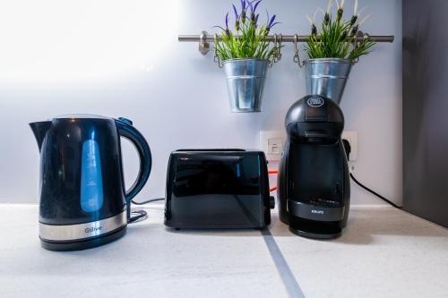 two appliances sitting on a counter next to a toaster at *SPACIOUS APARTMENT DISNEYLAND PARIS* in Serris