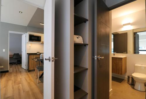 a bathroom with a toilet and a sink at Living 110 Suites by Wynwood House in Lima