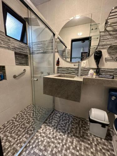 a bathroom with a shower and a sink and a mirror at Hotel Tepeyac in San Cristóbal de Las Casas