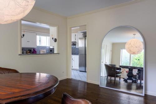 a dining room with a table and a mirror at Lakeview East Apartment in Chicago