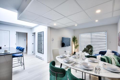 a dining room and living room with a table and chairs at Montreal Restful Nights, Adventure Days await! in Montréal