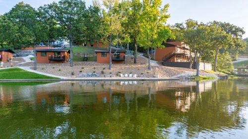 a group of birds sitting on the edge of a lake at Sunset Beach Resort in Osage Beach