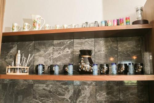 a shelf with a bunch of ceramics on it at Lake house 3 bedroom Pool and hotub in San Cristóbal Zapotitlán
