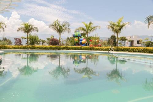 a swimming pool with a water park in the background at Lake house 3 bedroom Pool and hotub in San Cristóbal Zapotitlán