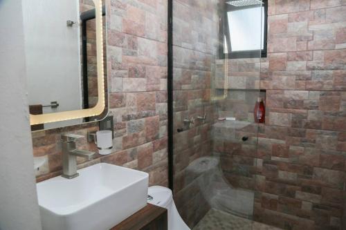 a bathroom with a toilet and a sink and a shower at Lake house 3 bedroom Pool and hotub in San Cristóbal Zapotitlán