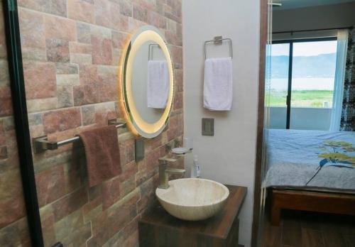 a bathroom with a bowl sink in a brick wall at Lake house 3 bedroom Pool and hotub in San Cristóbal Zapotitlán
