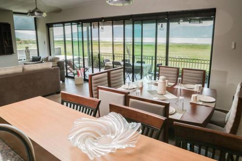 a restaurant with tables and chairs with a view of the ocean at Lake house 3 bedroom Pool and hotub in San Cristóbal Zapotitlán