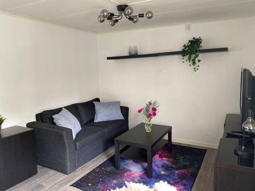 a living room with a couch and a table at Guesthouse in Västerås