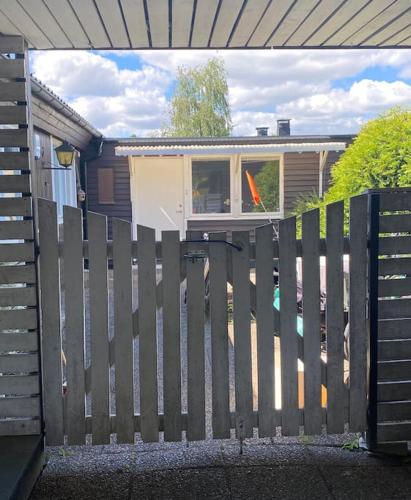 a wooden fence in front of a house at Guesthouse in Västerås