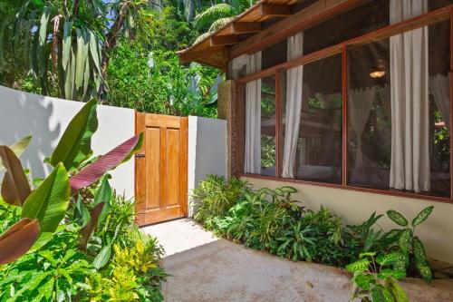 an entrance to a house with a wooden door at Ian Anderson Caves Branch Jungle Lodge in Belmopan