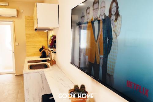 a kitchen with a large television on a wall at Gook Home CENTER in Jerez de la Frontera