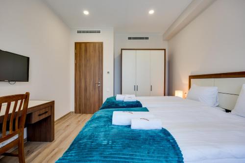 Postel nebo postele na pokoji v ubytování HOTEL WEST TBILISI