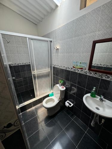 a bathroom with a shower and a toilet and a sink at Villa Cristina San Javier in La Mesa