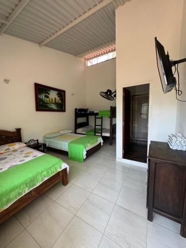 a bedroom with two beds and a flat screen tv at Villa Cristina San Javier in La Mesa