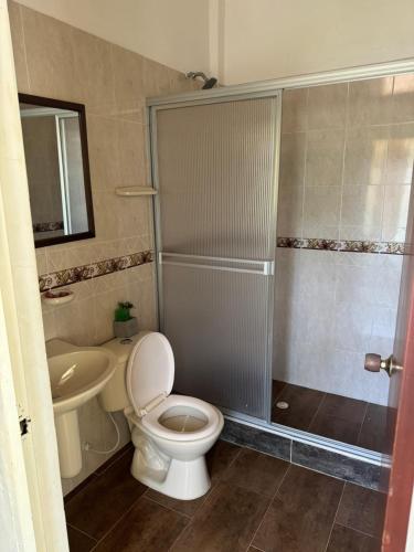 a bathroom with a toilet and a shower and a sink at Villa Cristina San Javier in La Mesa