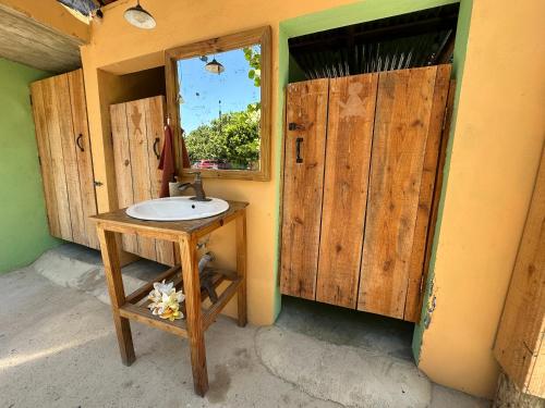 a bathroom with a sink and a window at Buen Hombre Kite School with Accommodations in La Costa de Buen Hombre