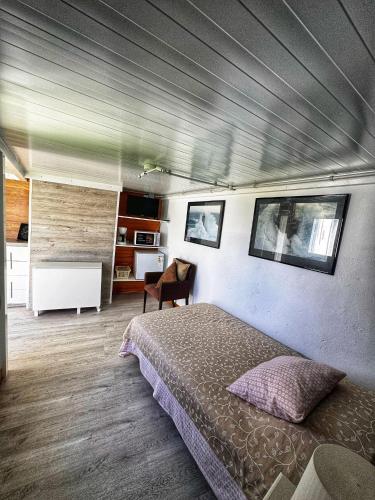 a bedroom with a bed and a chair in it at Habitación Namasté in Playa Blanca