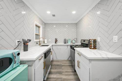 a kitchen with white counters and white appliances at Comfortable 1BR Apt in Central Houston with Free Park in Houston