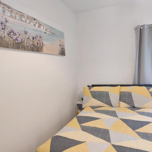 a bedroom with two beds and a painting on the wall at Amber Lodge- No party Room in Belfast