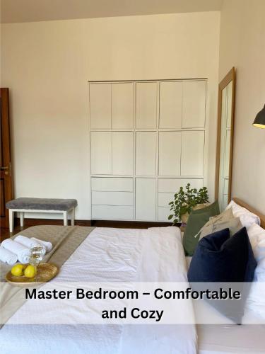 a bedroom with a bed with a large white cabinet at Spacious Old Town Apt, 3 Private Rooms, Sleeps 6-7 in Kaunas