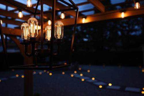 a chandelier with lights hanging from a ceiling at Centrally Located! Remodeled! Huge Backyard! The White House in Albuquerque