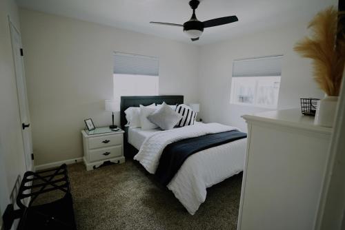 a bedroom with a bed and a ceiling fan at Centrally Located! Remodeled! Huge Backyard! The White House in Albuquerque