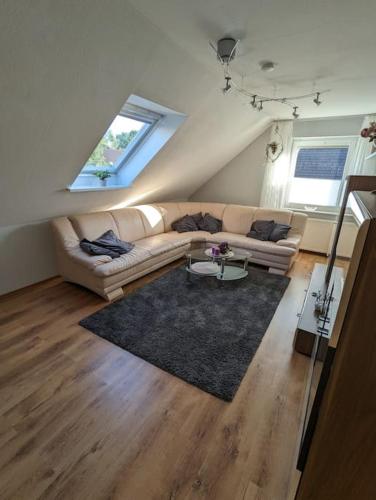 a living room with a couch and a table at Moin MML in Moormerland