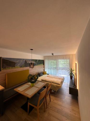 a bedroom with a bed and a table and a dining room at SiJa in Mühlbach