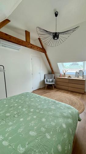 une chambre avec un lit vert et une fenêtre dans l'établissement Maison à 5 min à pieds de la mer, à Riantec