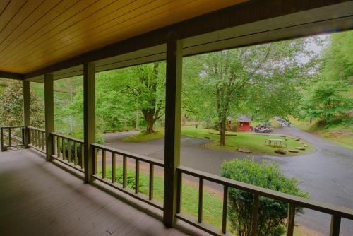 a screened porch with a view of a park at Historic Tapoco Lodge Resort in Tapoco