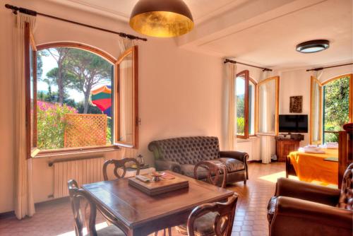 a living room with a table and chairs at Nel verde in Rapallo