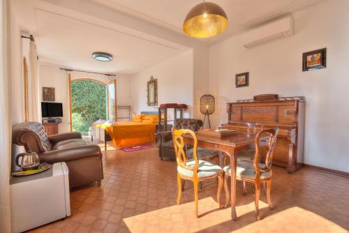 a living room with a table and chairs and a couch at Nel verde in Rapallo